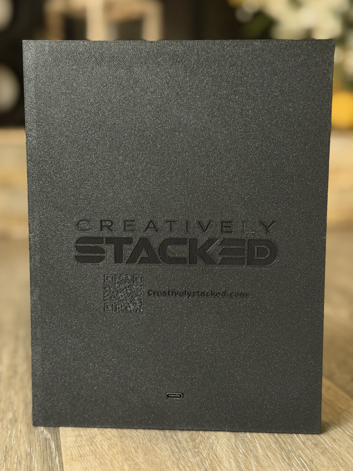 Back of Creatively Stacked black frame showing branding, QR code and USB-C power port