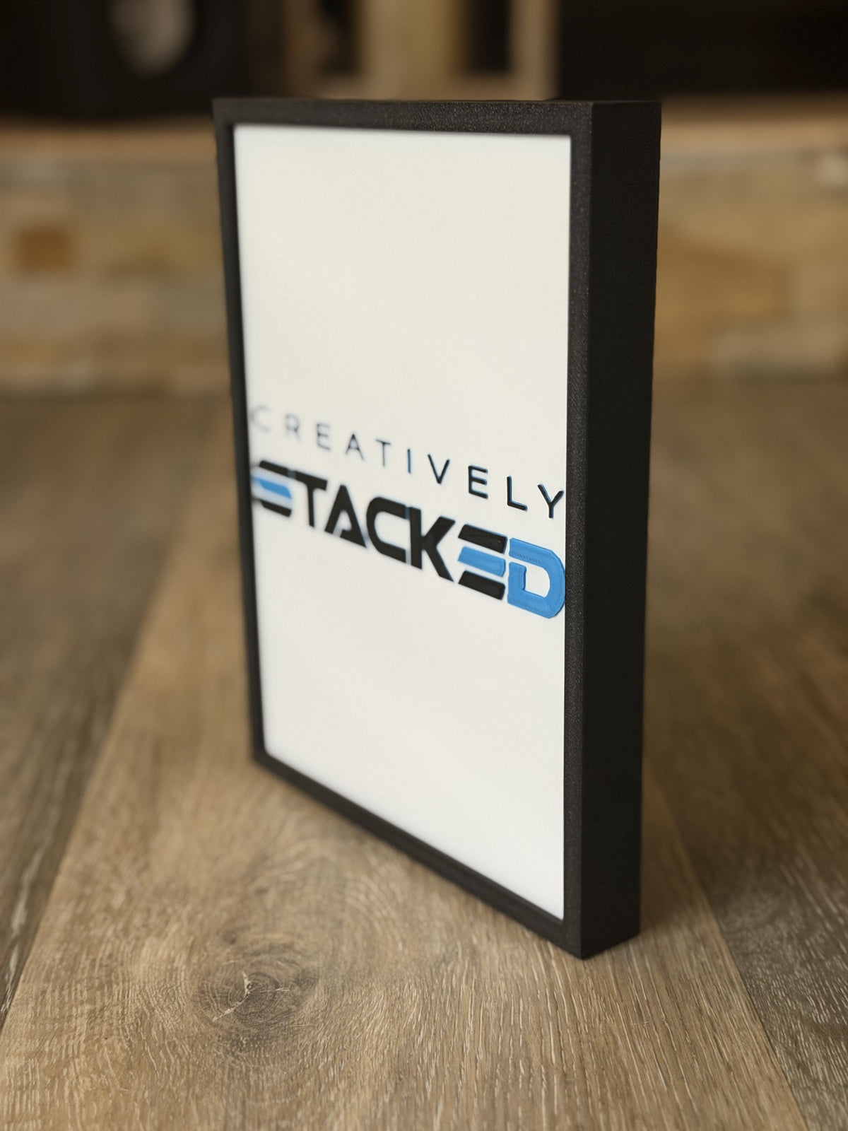 Creatively Stacked light-up 3D printed stained-glass-style artwork in black frame, front and side view